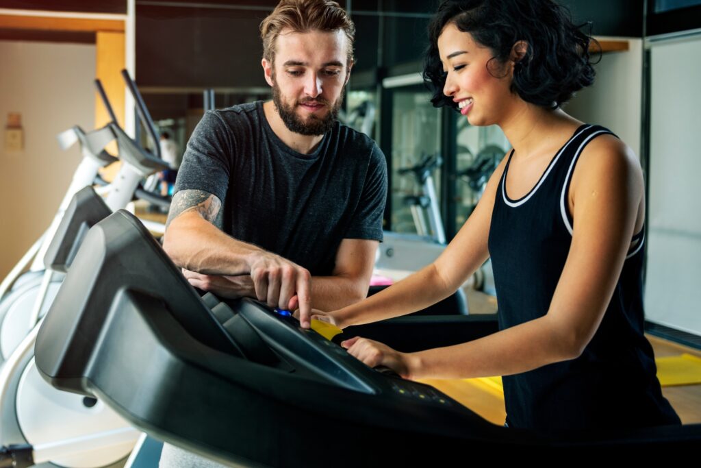 Couple Working Out Together At The Gym